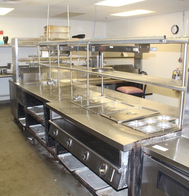 HUGE! Commercial Stainless Steel L-Shaped Food Warming/Prep Tables With Shelves. 135x122x66. Working When Closed! Buyer Must Disassemble Remove. Please See All Photos As This Is A Very Large Item.  - Image 1 of 11