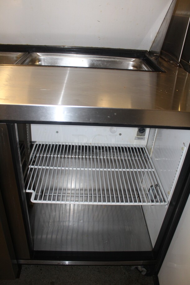 FANTASTIC! True Model TSSU-48-12 Commercial Stainless Steel Sandwich/Salad Refrigerated Prep Table On Commercial Casters With Shelves. 48x31x69. 115V/60Hz. Working When Closed! Buyer Must Remove.  - Image 5 of 6