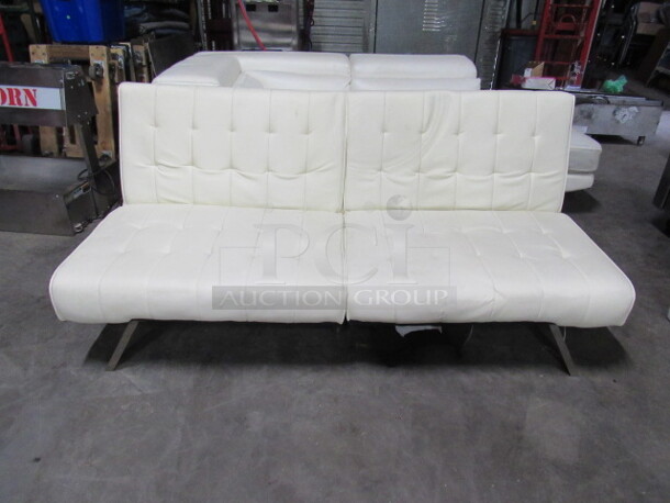 One White Cushioned Futon With Chrome Base. 71X35X32