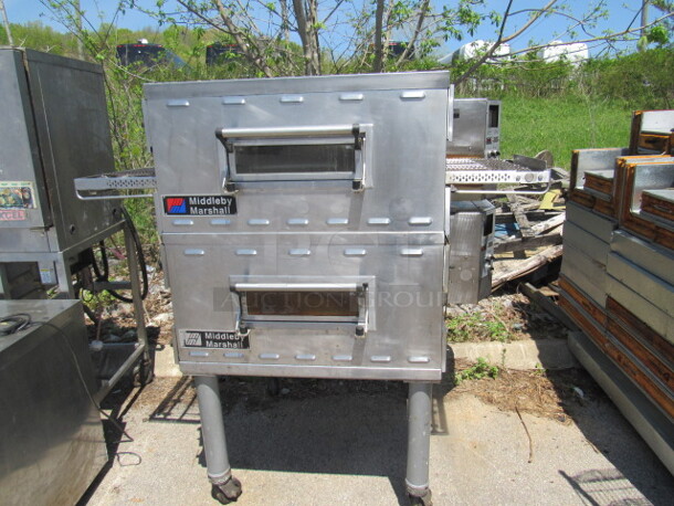 Double Stack Middleby Marshall Electric Conveyor Pizza Ovens On SS Table With Casters. Model# PS536E. CONTROLLERS HAVE BEEN REMOVED. 208 Volt. 3 Phase. DOUBLE STACK 2 PIZZA OVENS MAKE 1 UNIT. 2XBID. YOU WILL GET 1 DOUBLE STACK UNIT!!!! 61X44X63. - Image 1 of 5