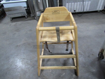 One Wooden High Chair With Safety Straps.