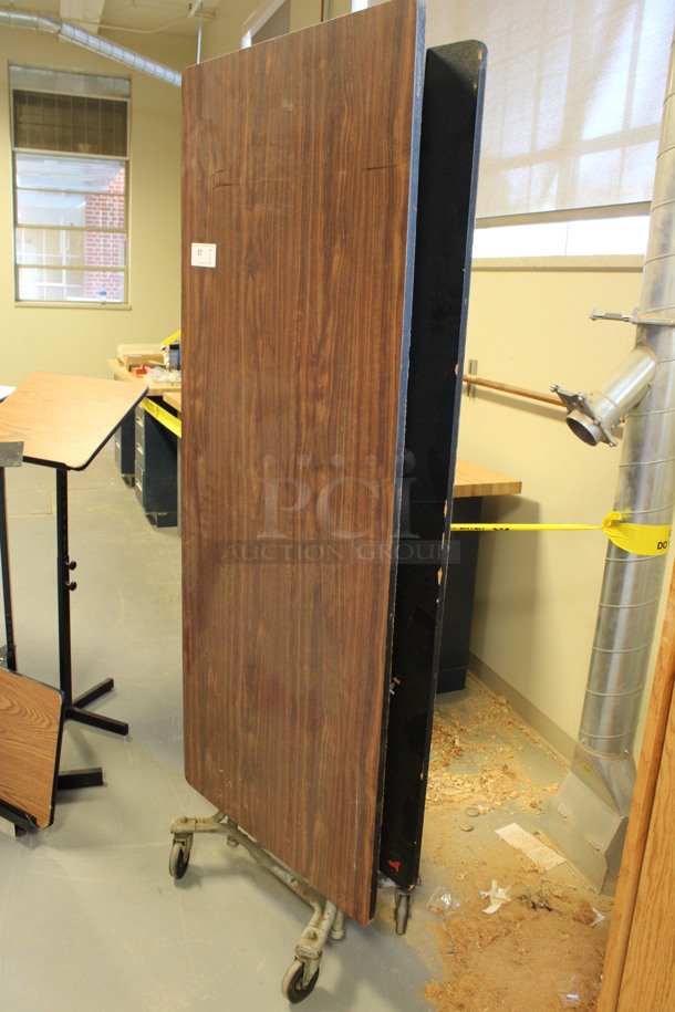 Wood Pattern Folding Table on Commercial Casters. 29.5x16x80. (Room 130)