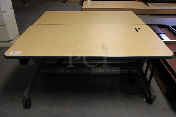 2 Wood Pattern Table on Casters. 60x30x27. 2 Times Your Bid! (Room 130)