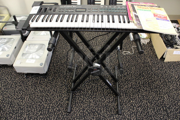 Yamaha Model DX11 Keyboard on Stand w/ 4 Music Books.120 Volts, 1 Phase. 35.5x11x2, 21x20x34. (2nd Floor: Room 220)