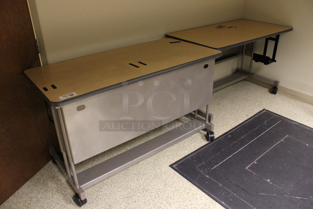 2 Wood Pattern Tables on Casters. 60x30x36. 2 Times Your Bid! (Hallways Straight Off Of Atrium)
