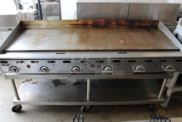 Vulcan Hart Model 972RX-102 Stainless Steel Commercial Countertop Propane Gas Powered Flat Top Griddle w/ Thermostatic Controls on Stainless Steel Equipment Stand w/ Commercial Casters. 162,000 BTU. 72x33x39