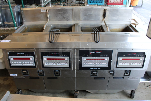 Henny Penny Model OFG-322 ENERGY STAR Stainless Steel Commercial Propane Gas Powered 4 Bay Deep Fat Fryer w/ 2 Metal Fry Baskets and Filtration System on Commercial Casters. 170,000 BTU. 67x33.5x44