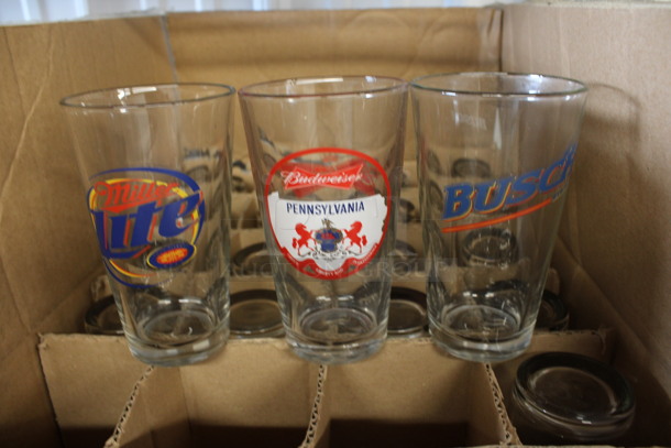 24 Beverage Glasses w/ Various Logos. 3.5x3.5x6. 24 Times Your Bid!