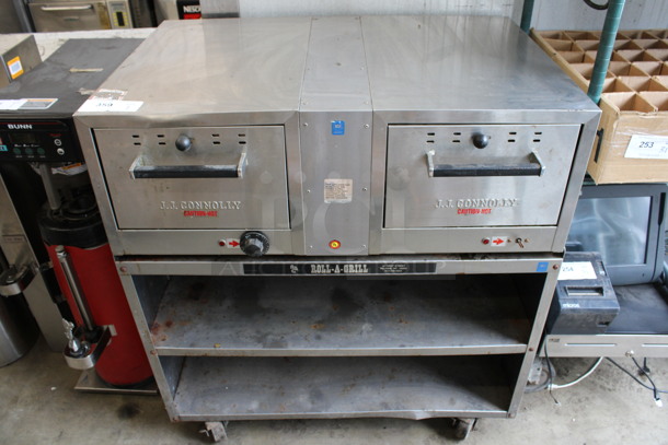 JJ Connolly Roll-a-grill Stainless Steel Commercial Countertop 2 Drawer Warming Drawer on Stainless Steel Equipment Stand w/ 2 Under Shelves and Commercial Casters. 35x26x38. Tested and Right Side Is Working But Left Side Does Not Work