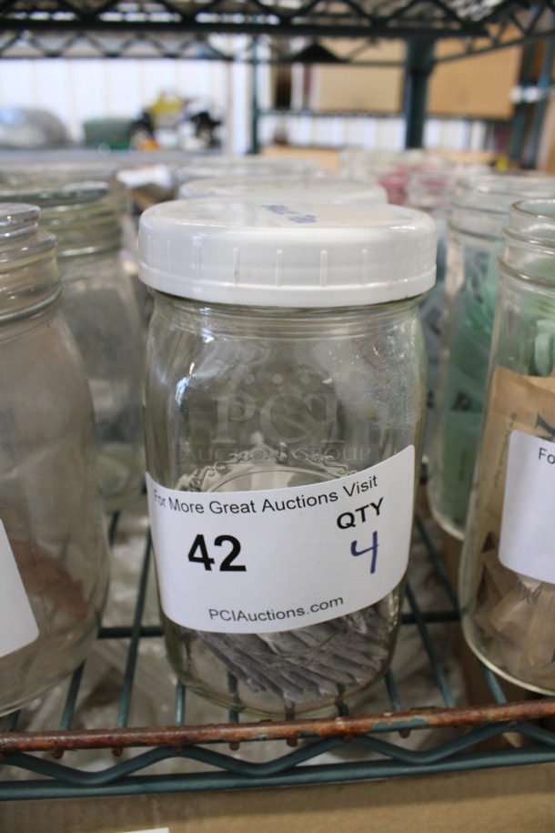 4 Glass Jars w/ Lids. 3.5x3.5x6.5. 4 Times Your Bid! - Image 1 of 2