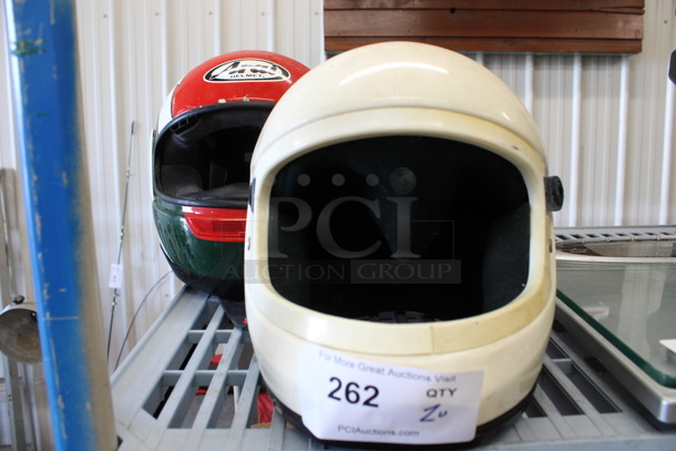 2 Racing Helmets; 1 is Nell Size M. Includes 10x14x9. 2 Times Your Bid!