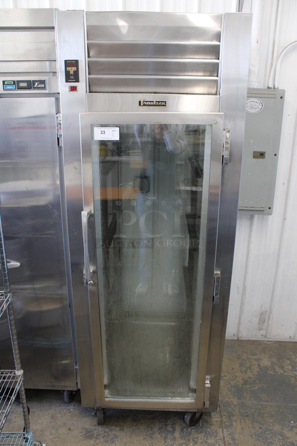 Traulsen Model RHT132WPUT-FHG Stainless Steel Commercial Single Door Reach In Cooler Merchandiser on Commercial Casters. 115 Volts, 1 Phase. 30x34x83. Tested and Powers On But Does Not Get Cold