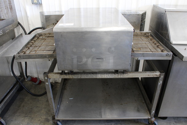 2014 Turbochef Model HCS2080 Stainless Steel Commercial Countertop Rapid Cook Conveyor Pizza Oven on Metal Equipment Stand w/ Commercial Casters. 208/240 Volts, 1 Phase. 58x34x45