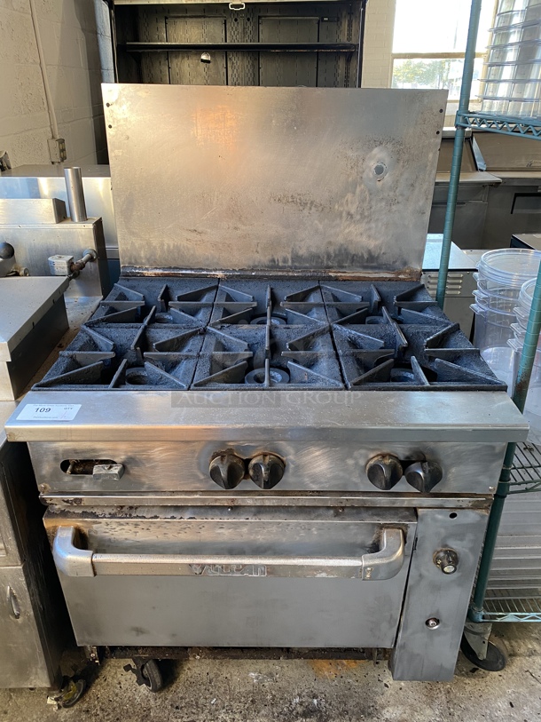 LATE MODEL! Vulcan Stainless Steel Commercial Natural Gas Powered 6 Burner Range w/ Oven and Backsplash on Commercial Casters. 36x34x58