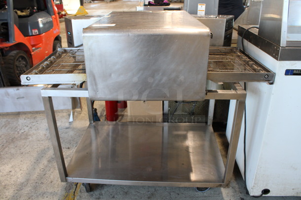 2012 Turbochef Model HhC2020 Stainless Steel Commercial Countertop Rapid Cook Conveyor Pizza Oven w/ Metal Equipment Stand on Commercial Casters. 208/240 Volts, 1 Phase. 49x34x44