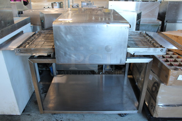 2012 Turbochef Model HhC2020 Stainless Steel Commercial Countertop Rapid Cook Conveyor Pizza Oven w/ Metal Equipment Stand on Commercial Casters. 208/240 Volts, 1 Phase. 54x34x44