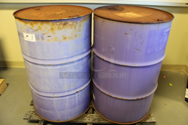 2 Metal Oil Barrels Full Of Liquid. Barrels Are Labeled as AW 46 Hydraulic Oil and ESL Gear Oil. 23x23x25. 2 Times Your Bid! (Room 130)