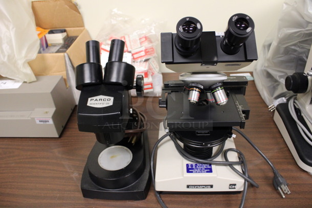 2 Various Metal Countertop Microscopes w/ Covers; Parco and Olympus. 7x9x15, 6x9x12. 2 Times Your Bid! (Room 105)