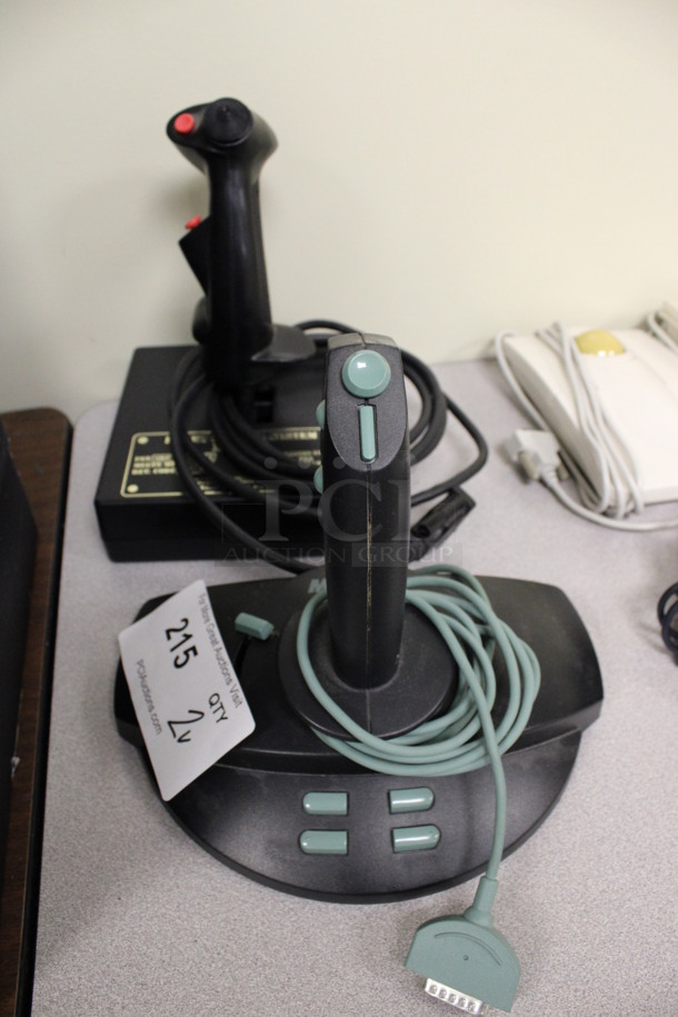 2 Various Flight Control Systems Including Thrustmaster Mark I and Microsoft. 9x6x8, 6x6x8. 2 Times Your Bid! (Room 105)