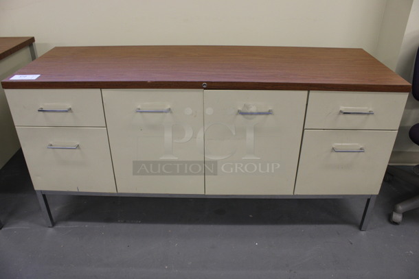 Tan Metal Counter w/ 4 Drawers, 2 Doors and Wood Pattern Countertop. 60x20x29.5. (Basement: Room 019)