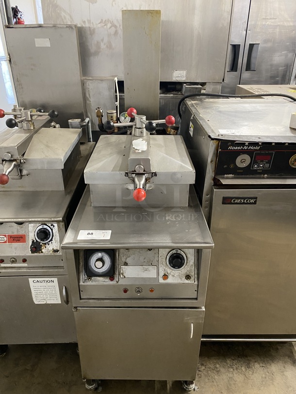 Henny Penny Stainless Steel Commercial Floor Style Electric Powered Pressure Fryer on Commercial Casters. 208 Volts, 3 Phase. 18x38x58