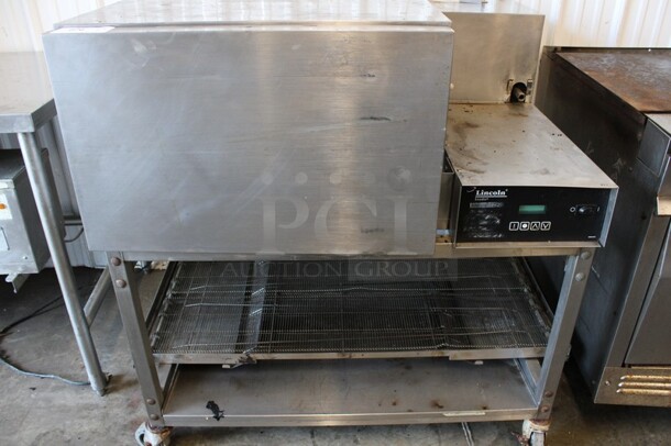 Lincoln Impinger Stainless Steel Commercial Electric Powered Single Deck Conveyor Pizza Oven on Commercial Casters. Comes w/ Conveyor Belt But Belt Does Not Fit Oven. 480 Volts, 3 Phase. 57x37x44