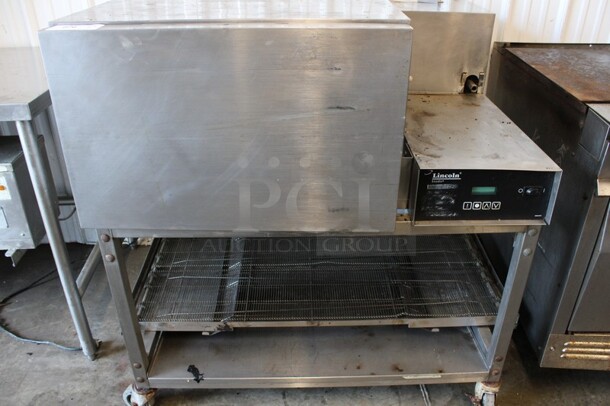 Lincoln Impinger Stainless Steel Commercial Electric Powered Single Deck Conveyor Pizza Oven on Commercial Casters. Comes w/ Conveyor Belt But Belt Does Not Fit Oven. 480 Volts, 3 Phase. 57x37x44 - Image 1 of 7