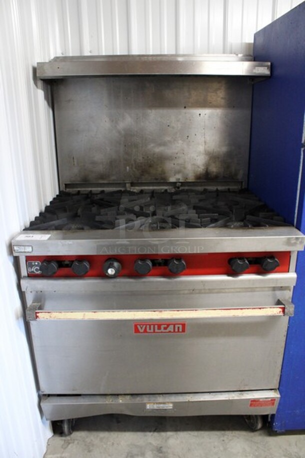 Vulcan Stainless Steel Commercial Natural Gas Powered 6 Burner Range w/ Oven, Over Shelf and Backsplash on Commercial Casters. 36x32x62