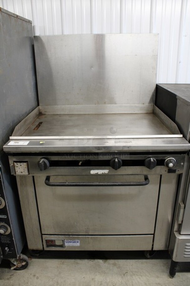 Southbend Model X436D-3G Stainless Steel Commercial Natural Gas Powered Flat Top Griddle w/ Oven and Backsplash on Commercial Casters. 36x34x60