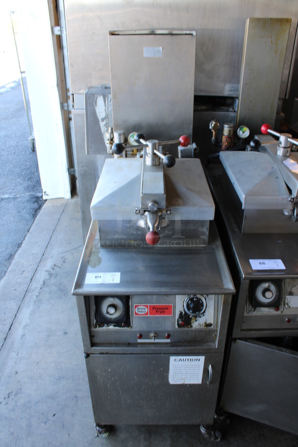Henny Penny Stainless Steel Commercial Electric Powered Floor Style Electric Powered Pressure Fryer on Commercial Casters. 208 Volts, 3 Phase. 18x38x58