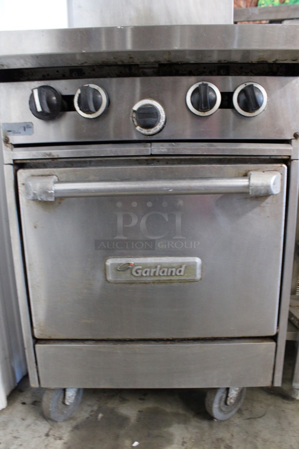 Garland Stainless Steel Commercial Natural Gas Powered 4 Burner Range w/ Oven and Backsplash on Commercial Casters. 24x35x57 - Image 4 of 5