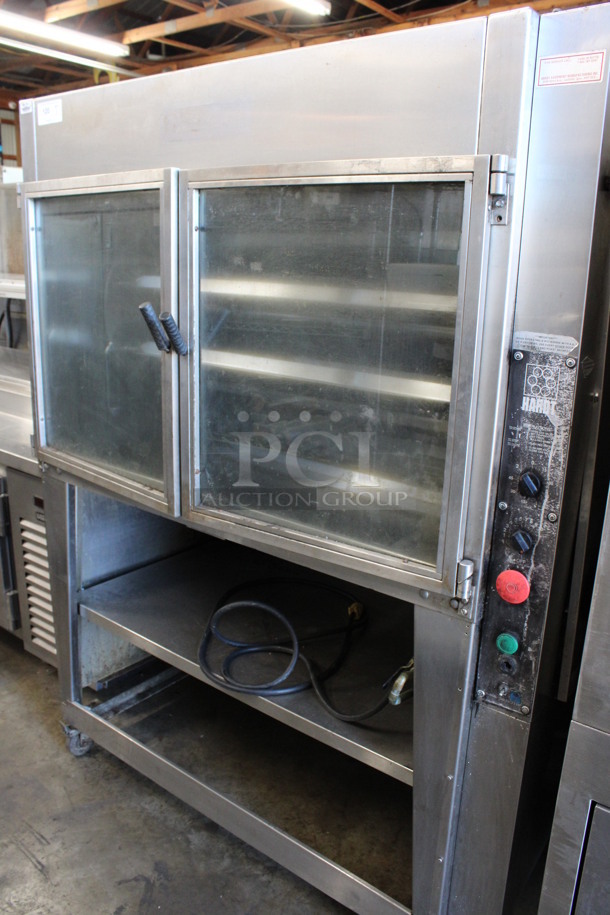Hardt Model Inferno Stainless Steel Commercial Natural Gas Powered 7 Spit Rotisserie Oven on Commercial Casters. 150,000 BTU. 58x41x77