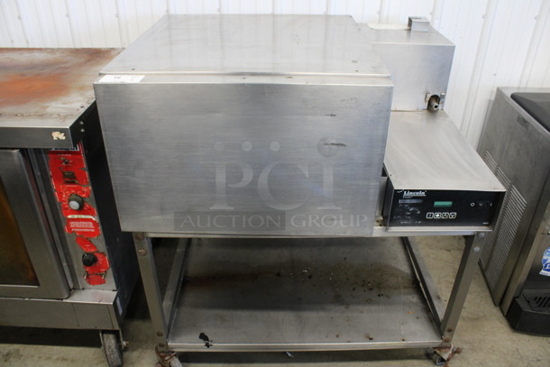 Lincoln Impinger Stainless Steel Commercial Electric Powered Single Deck Conveyor Pizza Oven on Commercial Casters. Does Not Have Conveyor. 480 Volts, 3 Phase. 57x37x44