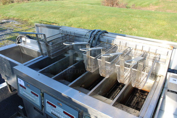 Henny Penny Model LVG-SSS Stainless Steel Commercial Floor Style Natural Gas Powered 3 Bay Deep Fat Fryer w/ 6 Metal Fry Baskets on Commercial Casters. 225,000 BTU. 47x32x48 - Image 3 of 8