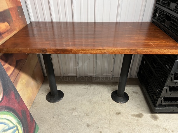 Wooden Dining Height Table on 2 Metal Bases. Stock Picture - Cosmetic Condition May Vary. 48x25x30.5