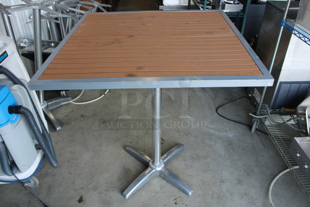 Outdoor Tabletop w/ Wood Pattern Planks and Metal Rim and Metal Bar Height Table Base. Stock Picture - Cosmetic Condition May Vary. 35.5x35.5x41