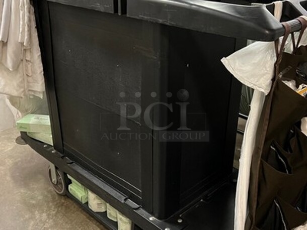 Black Commercial House Keeping Cart on Casters With Contents! Includes Pens, Shampoos, Body Lotions, Body Washes, Remotes, Dusters, Linens, Toilet Paper, Tissue Boxes, and More! 57x22x45 - Image 5 of 6
