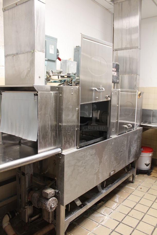 CMA Model EST-66 Stainless Steel Commercial Conveyor Dishwasher With Drainboards, Overshelf, and Hatco Water Booster. Left Drain Board: 95x29x38, Dishwasher: 83x25x70, Right L Shaped Drain Board: 90x154x72. Winning Bidder Can Take What They Want From Lot. BUYER MUST REMOVE!