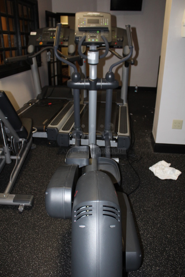 Life Fitness Elliptical With Various Work Out Programs, Adjustable Resistance Levels, Heart Rate Monitoring, Non-Slip Pedals, and Cupholder. 72x30x64. BUYER MUST REMOVE!