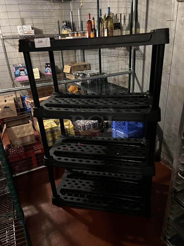 Black Poly 4 Tier Shelving Unit. Does Not Come w/ Contents. BUYER MUST DISMANTLE. PCI CANNOT DISMANTLE FOR SHIPPING. PLEASE CONSIDER FREIGHT CHARGES. 36x18x57. (kitchen)