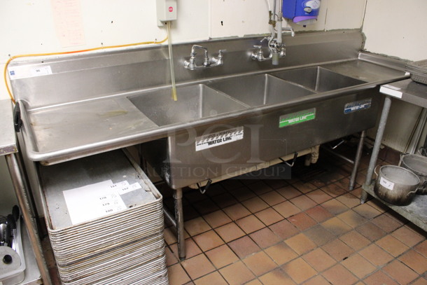Stainless Steel Commercial 3 Bay Sink w/ Dual Drainboards, Faucet, Handles and Spray Nozzle Attachment. BUYER MUST REMOVE. 108x30x44. Bays 20x24x12. Drainboards 21x26x2. (kitchen)