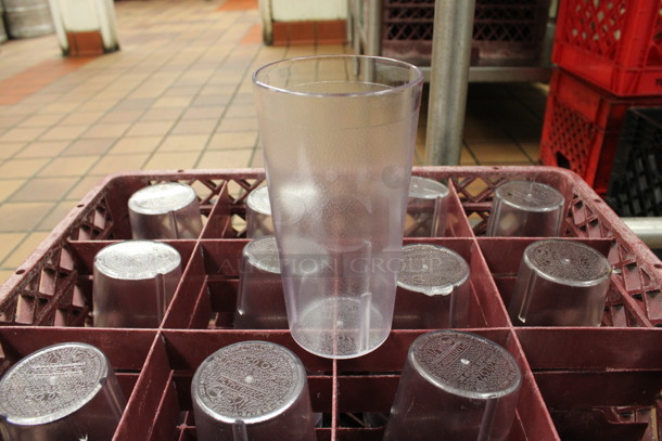 ALL ONE MONEY! Lot of 48 Clear Poly Beverage Tumblers in 2 Red Dish Caddies. 3.5x3.5x6.5. (kitchen) - Image 1 of 3