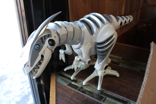 White and Gray Countertop Dinosaur Toy. 8x30x11. (bar)