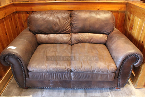 Brown 2 Person Couch w/ Nailhead Trim. 67x38x38. (dining room)