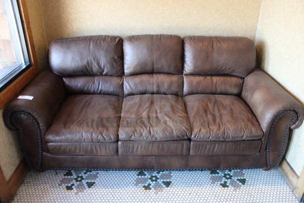 Brown 3 Person Couch w/ Nailhead Trim. 84x39x38. (vestibule)
