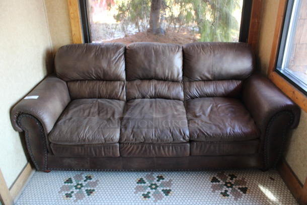 Brown 3 Person Couch w/ Nailhead Trim. 84x39x38. (vestibule)