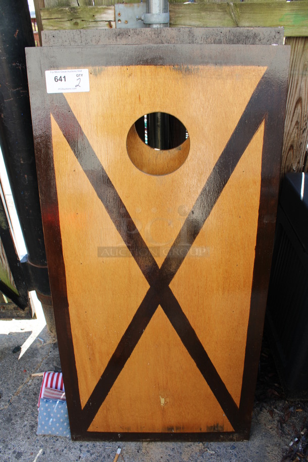 2 Brown Wooden Cornhole Boards w/ 4 Bean Bags. 24x48x4. 2 Times Your Bid! (outside behind kitchen)