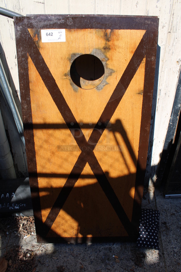 2 Brown Wooden Cornhole Boards w/ 4 Bean Bags. 24x48x4. 2 Times Your Bid! (outside behind kitchen)