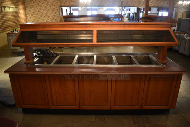 Portable Buffet Station w/ Hatco Heat Strip, Sneeze Guard and Wooden Exterior on Commercial Casters. 104x40x60.5. Unit Was In Working Condition When Restaurant Closed. BUYER MUST REMOVE. (buffet)