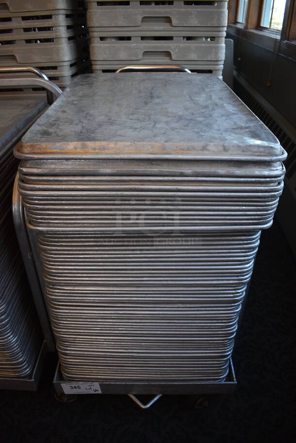 Metal Commercial Baking Pan Cart w/ Push Handle and 66 Full Size Metal Baking Pans on Commercial Casters. 29x21x32. 18x26x1. (back dining room) - Image 1 of 3